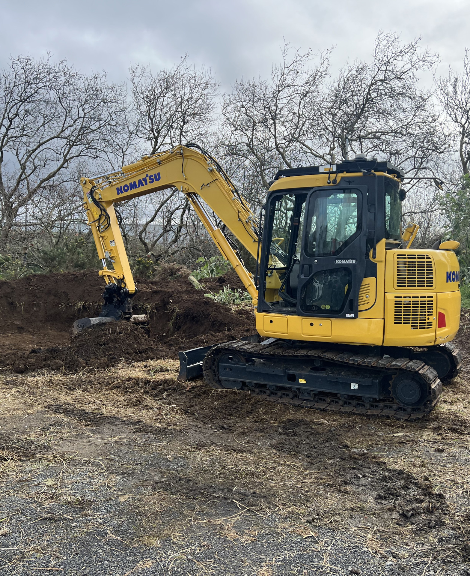 Komatsu excavator carrying out vegetation and land clearing on a large commercial site in Auckland